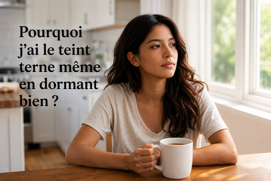 Jeune femme au teint terne tenant une tasse de café au réveil, illustrant pourquoi la peau peut manquer d'éclat malgré un sommeil de qualité.